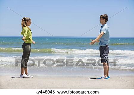 Woman exercising on the beach with her coach View Large Photo Image Stock Photography - Woman exercising on the beach with her coach. Fotosearch