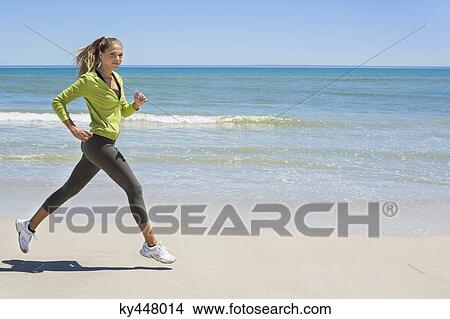 Woman jogging on the beach View Large Photo Image Picture - Woman jogging on the beach. Fotosearch