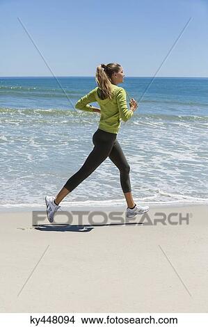 Woman jogging on the beach View Large Photo Image Picture - Woman jogging on the beach. Fotosearch