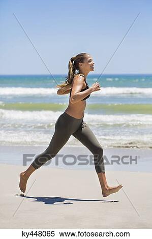 Woman jogging on the beach View Large Photo Image Stock Photography - Woman jogging on the beach. Fotosearch