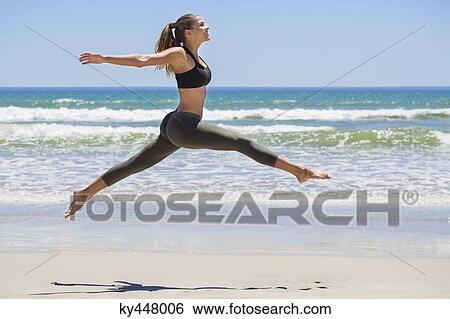 Woman jumping on the beach View Large Photo Image Stock Photograph - Woman jumping on the beach. Fotosearch