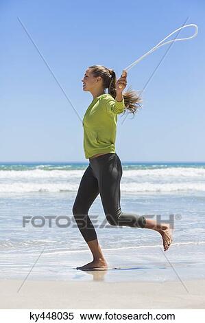 Woman jumping rope on the beach View Large Photo Image Stock Photography - Woman jumping rope on the beach. Fotosearch