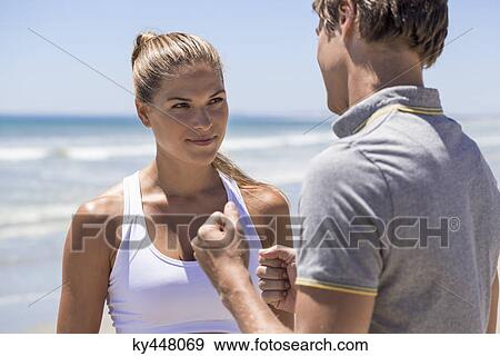 Woman talking to her coach on the beach View Large Photo Image Stock Photo - Woman talking to her coach on the beach. Fotosearch