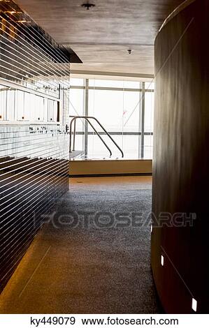 Corridor leading towards a swimming pool View Large Photo Image Stock Photo - Corridor leading towards a swimming pool. Fotosearch