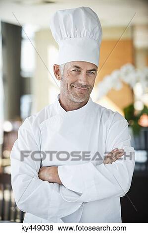 Portrait of a chef smiling with arms crossed View Large Photo Image Stock Photo - Portrait of a chef smiling with arms crossed. Fotosearch