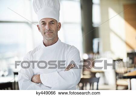Portrait of a chef with arms crossed in a restaurant View Large Photo Image Stock Photograph - Portrait of a chef with arms crossed in a restaurant. Fotosearch