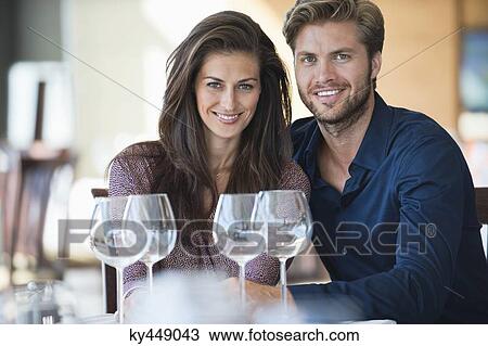 Portrait of a couple enjoying white wine in a restaurant View Large Photo Image Stock Image - Portrait of a couple enjoying white wine in a restaurant. Fotosearch
