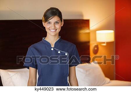 Portrait of a maid smiling in a hotel room View Large Photo Image Stock Image - Portrait of a maid smiling in a hotel room. Fotosearch