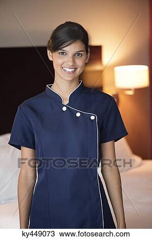 Portrait of a maid smiling in a hotel room View Large Photo Image Stock Image - Portrait of a maid smiling in a hotel room. Fotosearch