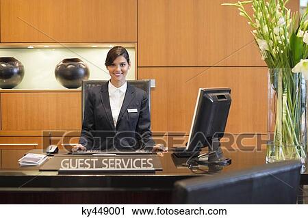 Portrait of a receptionist smiling at the hotel reception counter View Large Photo Image Stock Image - Portrait of a receptionist smiling at the hotel reception counter. Fotosearch