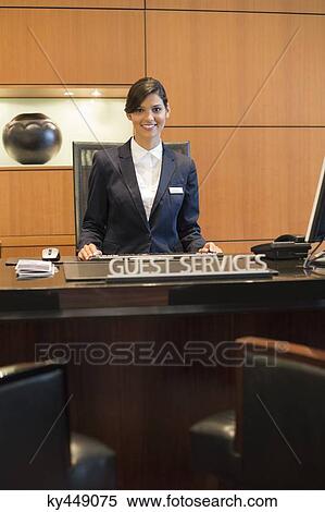Stock Photography - Portrait of a receptionist smiling at the hotel reception counter. Fotosearch