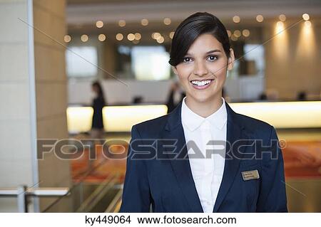Picture - Portrait of a receptionist smiling in a hotel lobby. Fotosearch