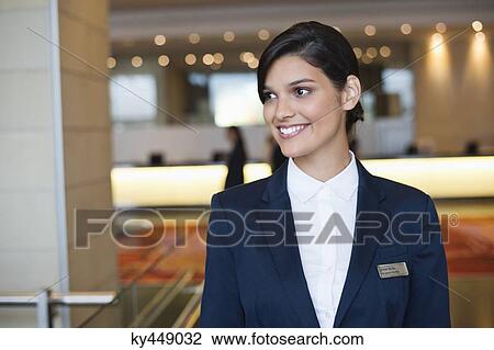 Receptionist smiling in a hotel lobby View Large Photo Image Stock Image - Receptionist smiling in a hotel lobby. Fotosearch