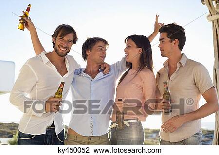 Four friends drinking beer View Large Photo Image Stock Image - Four friends drinking beer. Fotosearch