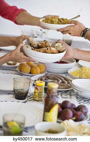 Friends having lunch at a dining table View Large Photo Image Stock Photo - Friends having lunch at a dining table. Fotosearch