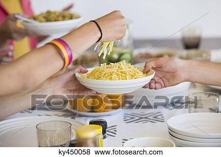 Friends having lunch at a dining table View Large Photo Image Stock Photo - Friends having lunch at a dining table. Fotosearch