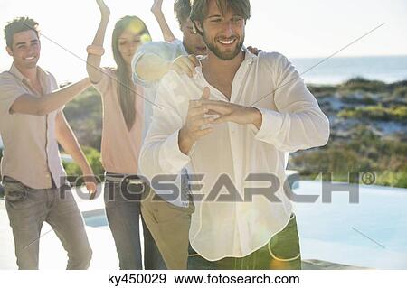 Group of friends dancing at the poolside View Large Photo Image Stock Photo - Group of friends dancing at the poolside. Fotosearch