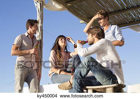 Group of friends enjoying beer View Large Photo Image Picture - Group of friends enjoying beer. Fotosearch