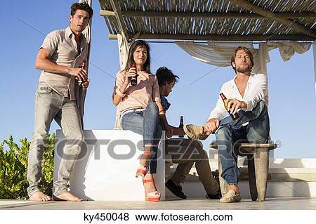Group of friends enjoying beer View Large Photo Image Stock Photo - Group of friends enjoying beer. Fotosearch