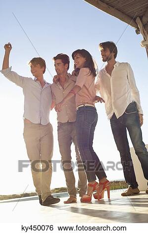 Group of friends enjoying good time together View Large Photo Image Stock Photograph - Group of friends enjoying good time together. Fotosearch