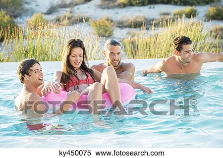 Group of friends enjoying in a swimming pool on the beach View Large Photo Image Stock Photography - Group of friends enjoying in a swimming pool on the beach. Fotosearch