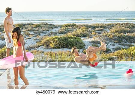 Three friends enjoying at a swimming pool on the beach View Large Photo Image Stock Photo - Three friends enjoying at a swimming pool on the beach. Fotosearch