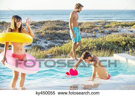 Three friends enjoying at a swimming pool on the beach View Large Photo Image Stock Photography - Three friends enjoying at a swimming pool on the beach. Fotosearch