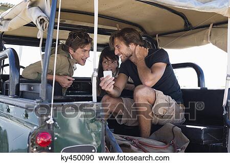 Three friends in SUV View Large Photo Image Stock Image - Three friends in SUV. Fotosearch