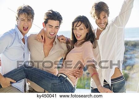 Three men lifting their female friend at the poolside View Large Photo Image Stock Image - Three men lifting their female friend at the poolside. Fotosearch