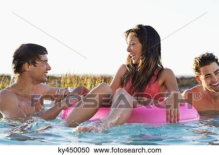 Woman enjoying in a swimming pool with her friends View Large Photo Image Stock Image - Woman enjoying in a swimming pool with her friends. Fotosearch