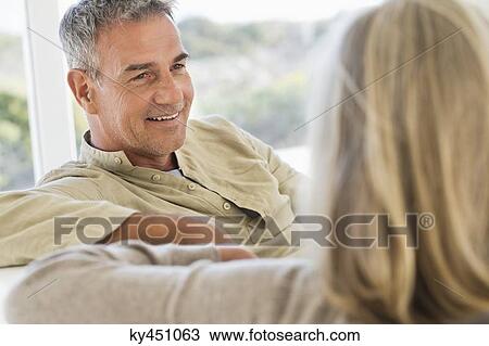 Close-up of a senior couple sitting on a couch View Large Photo Image Stock Image - Close-up of a senior couple sitting on a couch. Fotosearch