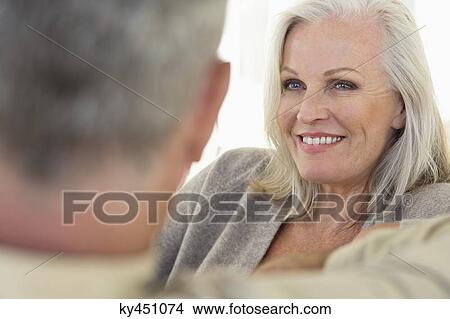 Close-up of a senior woman smiling with her husband View Large Photo Image Picture - Close-up of a senior woman smiling with her husband. Fotosearch