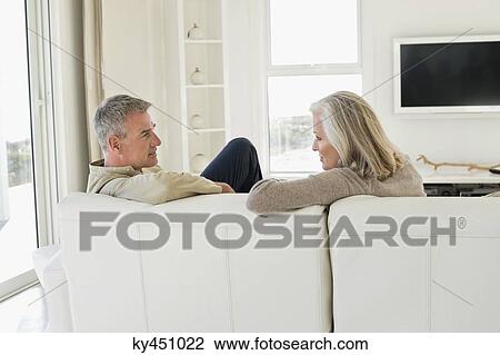 Stock Image - Couple sitting on a couch. Fotosearch