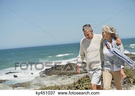 Stock Photo - Couple walking on the beach. Fotosearch