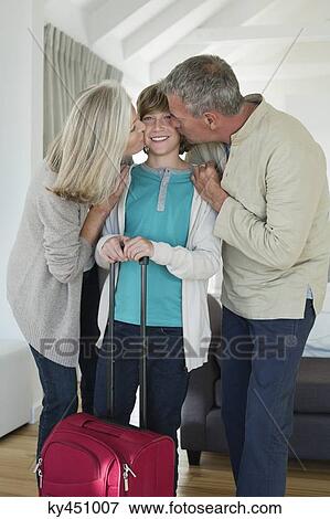 Grandparents kissing their grandson at home View Large Photo Image Stock Photo - Grandparents kissing their grandson at home. Fotosearch