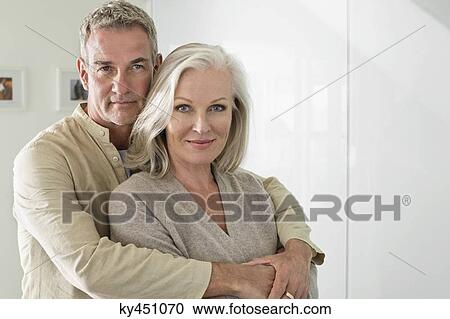 Man hugging his wife from behind View Large Photo Image Stock Image - Man hugging his wife from behind. Fotosearch