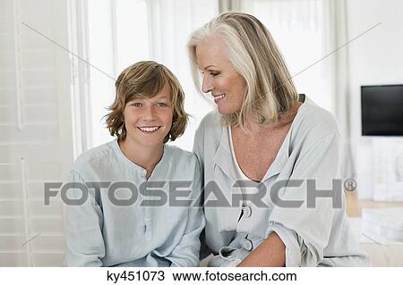 Portrait of a boy sitting with his grandmother and smiling View Large Photo Image Stock Image - Portrait of a boy sitting with his grandmother and smiling. Fotosearch