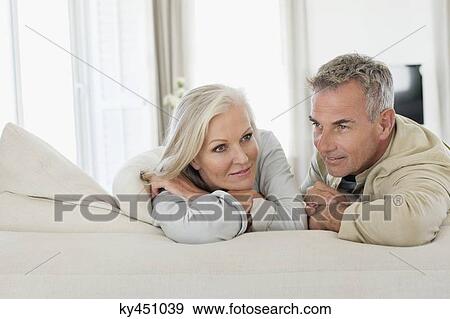 Stock Photo - Senior couple resting on the bed. Fotosearch