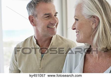 Stock Photo - Smiling senior couple looking at each other. Fotosearch