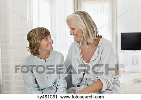 Woman and her grandson smiling at each other View Large Photo Image Stock Image - Woman and her grandson smiling at each other. Fotosearch