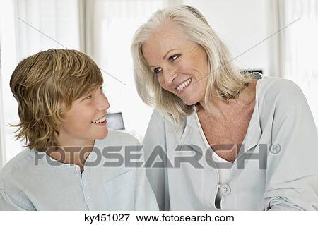 Woman and her grandson smiling at each other View Large Photo Image Stock Photo - Woman and her grandson smiling at each other. Fotosearch