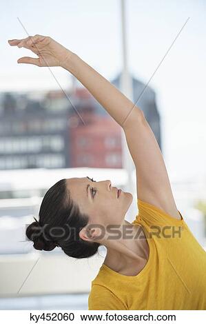 Stock Image - Close-up of a woman exercising in a gym. Fotosearch