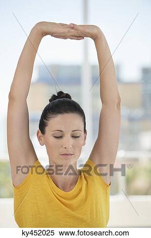 Close-up of a woman exercising in a gym View Large Photo Image Stock Photography - Close-up of a woman exercising in a gym. Fotosearch
