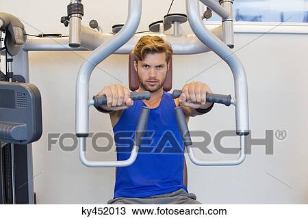 Portrait of a man exercising in a gym View Large Photo Image Stock Image - Portrait of a man exercising in a gym. Fotosearch