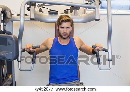Portrait of a man exercising in a gym View Large Photo Image Stock Photo - Portrait of a man exercising in a gym. Fotosearch