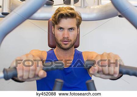 Portrait of a man exercising in a gym View Large Photo Image Stock Photo - Portrait of a man exercising in a gym. Fotosearch