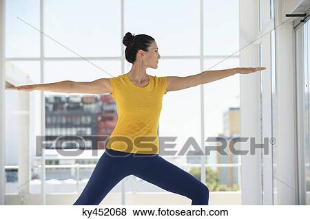 Woman exercising in a gym View Large Photo Image Stock Photo - Woman exercising in a gym. Fotosearch