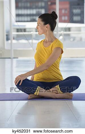 Woman exercising on exercise mat in a gym View Large Photo Image Stock Image - Woman exercising on exercise mat in a gym. Fotosearch