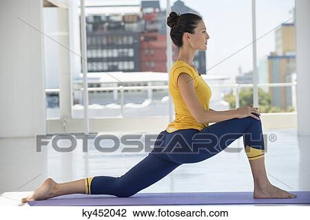 Woman exercising on exercise mat in a gym View Large Photo Image Stock Image - Woman exercising on exercise mat in a gym. Fotosearch