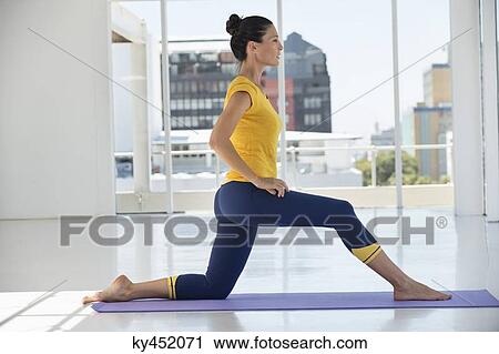 Woman exercising on exercise mat in a gym View Large Photo Image Stock Image - Woman exercising on exercise mat in a gym. Fotosearch